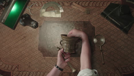 an older man evaluates an old mortar