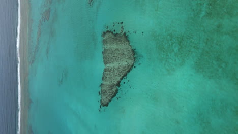 vertical aerial parallax over poé's heart off poé beach, new caledonia