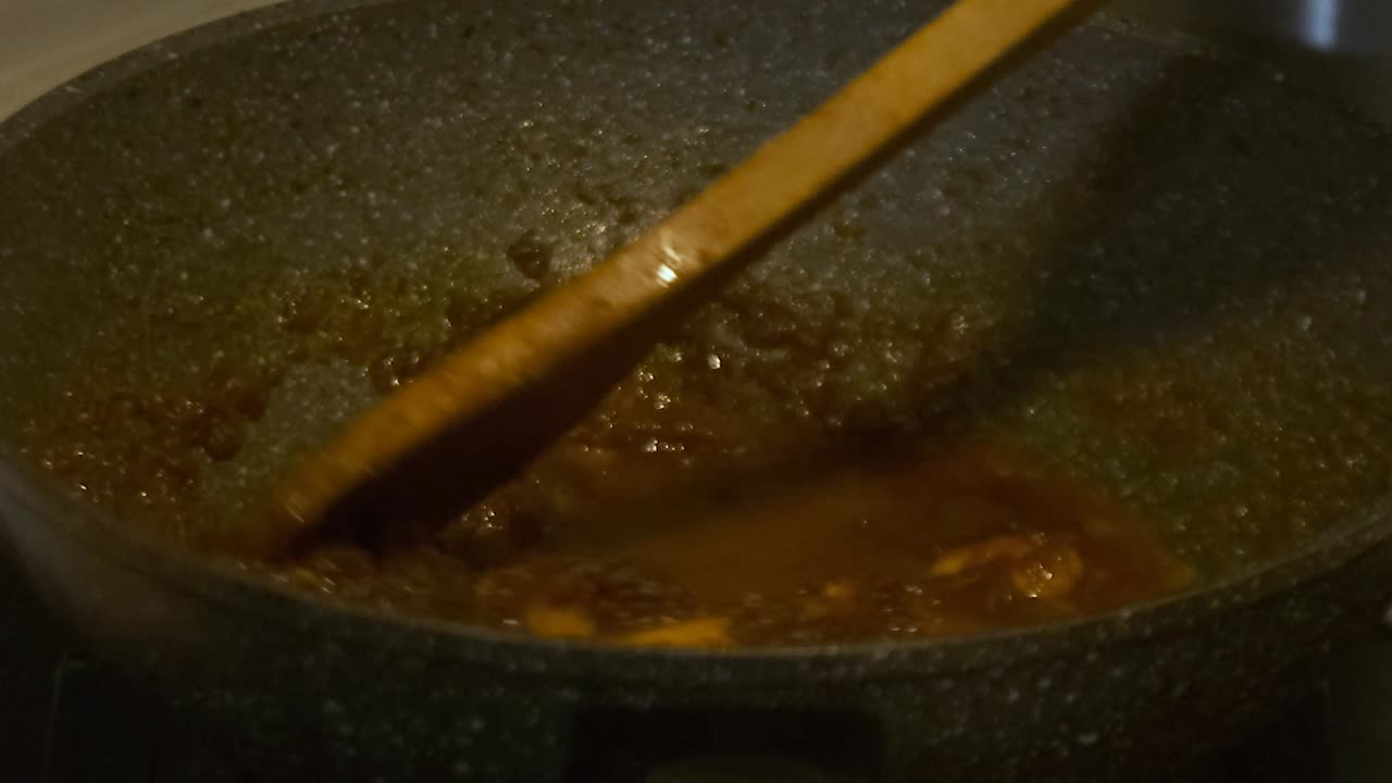 Closeup shot of adding water into Chilli Prawns Oriental Dish