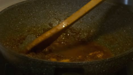 closeup shot of adding water into chilli prawns oriental dish