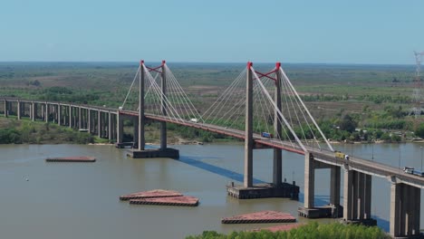 capturing an impressive cable stayed bridge crossing a tranquil river of justo jose de urquiza bridge over parana guazu river in argentina, built in the 70s by italian de miranda