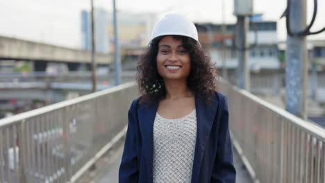confident female engineer on urban bridge