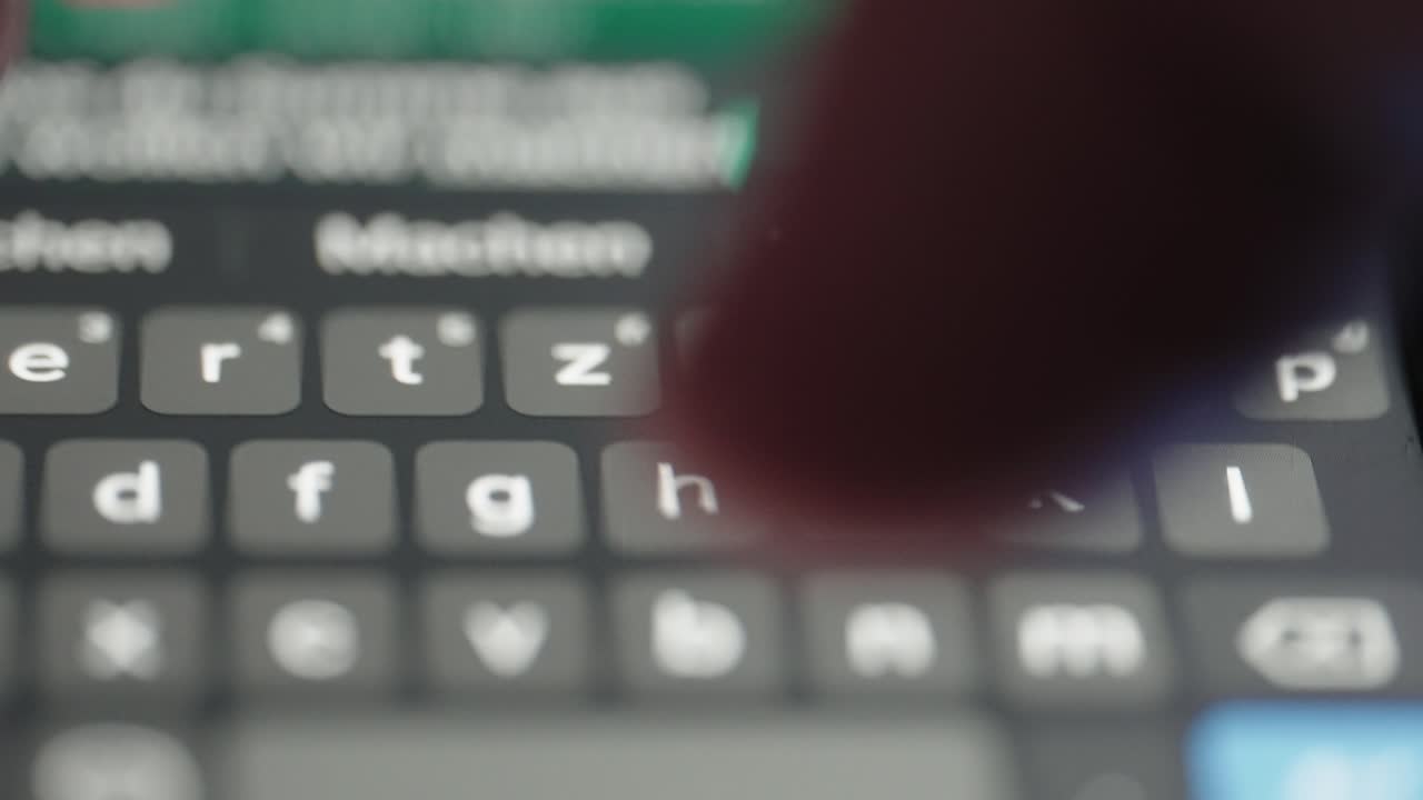 Person texting on a smartphone, macro footage closeup.