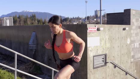 young fit girl running up steps exercising outdoors medium shot