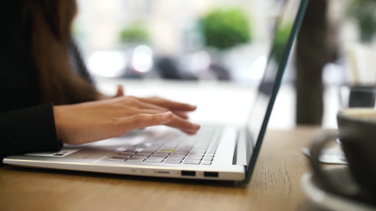 Woman working on a laptop in a cafe