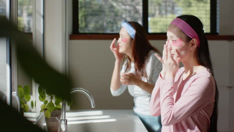 applying skincare products, asian mother and child bonding in bathroom, enjoying self-care