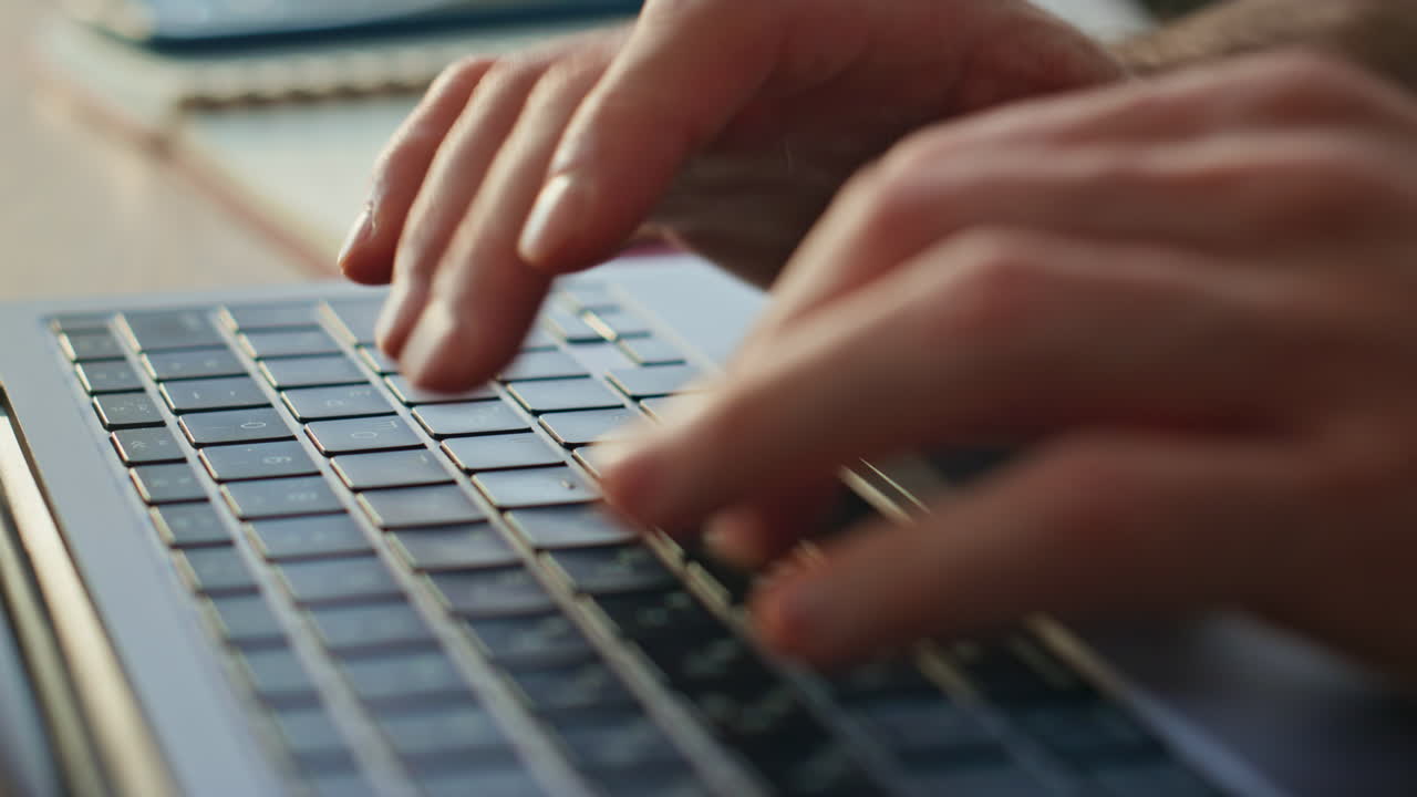 Unrecognizable writer typing keyboard laptop creating article at office close up
