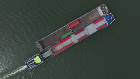 h2 barge flying under the flag of the netherlands sailing on the oude maas river