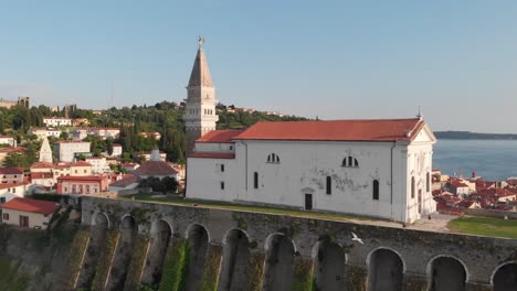 ancient catholic church on top of the cliff with adriatic sea in the background