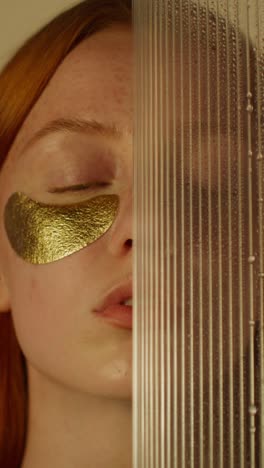 woman with gold eye patches and transparent glass