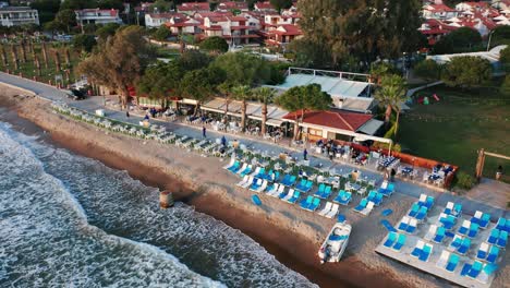 Picturesque-holiday-resort-on-sandy-beach,-reveal-of-hotel-building-at-Kusadasi,-Turkey