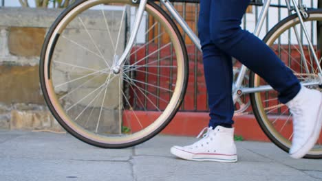 woman walking with bicycle in the city 4k