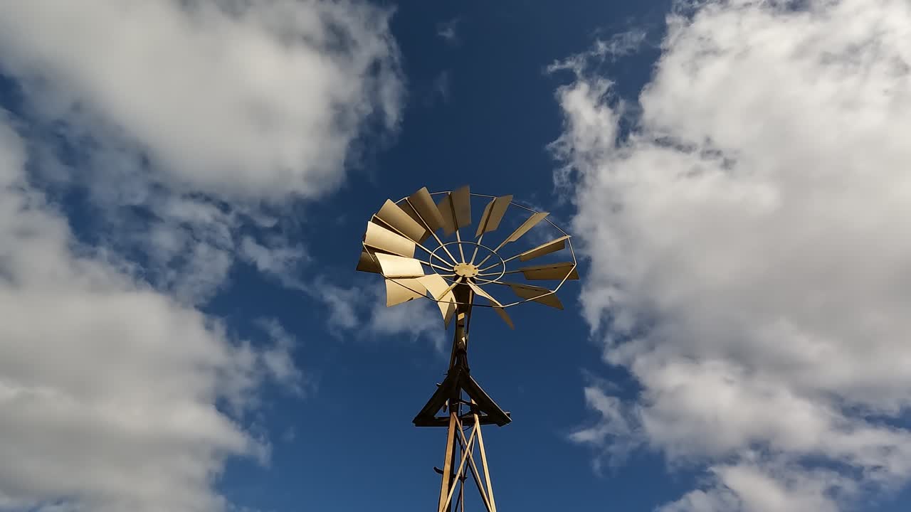 Golden Windmill under a Blue Sky