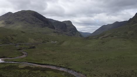 4k aerial drone footage in scotland scottish highlands open fields mountains and a stream of water