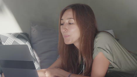 woman video calling lying on couch