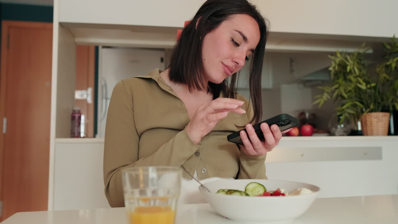 Happy Woman Using Phone at Breakfast