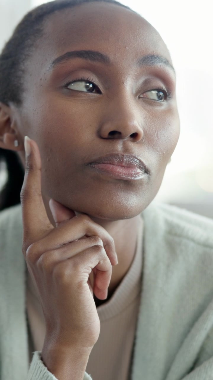 Thoughtful Young Woman Resting Chin on Hand