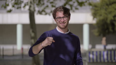 happy man gesturing and looking at camera