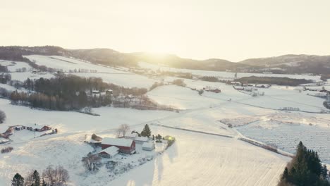 farm house and snowy rural landscape during sunrise