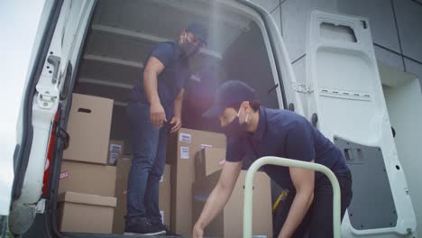 video of two couriers in protective masks unloading packages