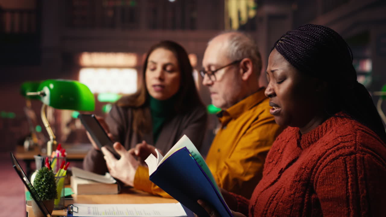 People Reading and Discussing in a Library