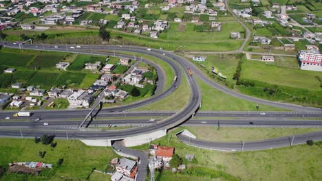 Explore-the-majesty-of-the-E35,-Pan-American-South,-at-the-Santa-Rosa-Curve-in-Cutuglahua-parish,-Mejía-Canton,-Pichincha-Province,-with-this-amazing-panning-aerial-video