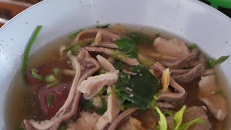 thai style blood pudding soup with guts, close up