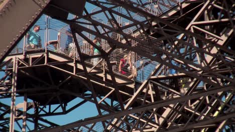 tourists walk on the eiffel tower in paris