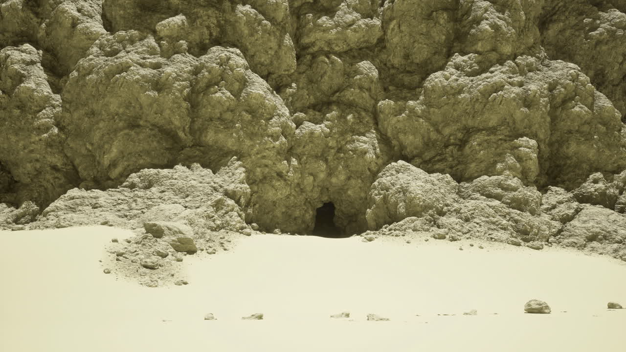 Natural cave entrance on a sandy landscape under bright sunlight