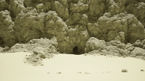 natural cave entrance on a sandy landscape under bright sunlight