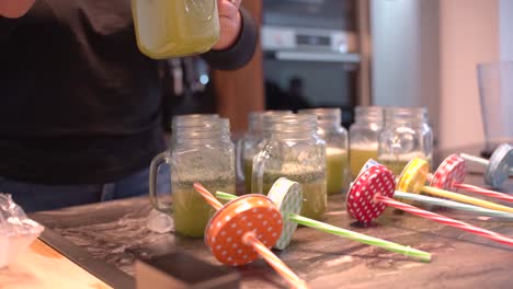 young latin girl prepare cocktail mocktail or smoothie at her kitchen