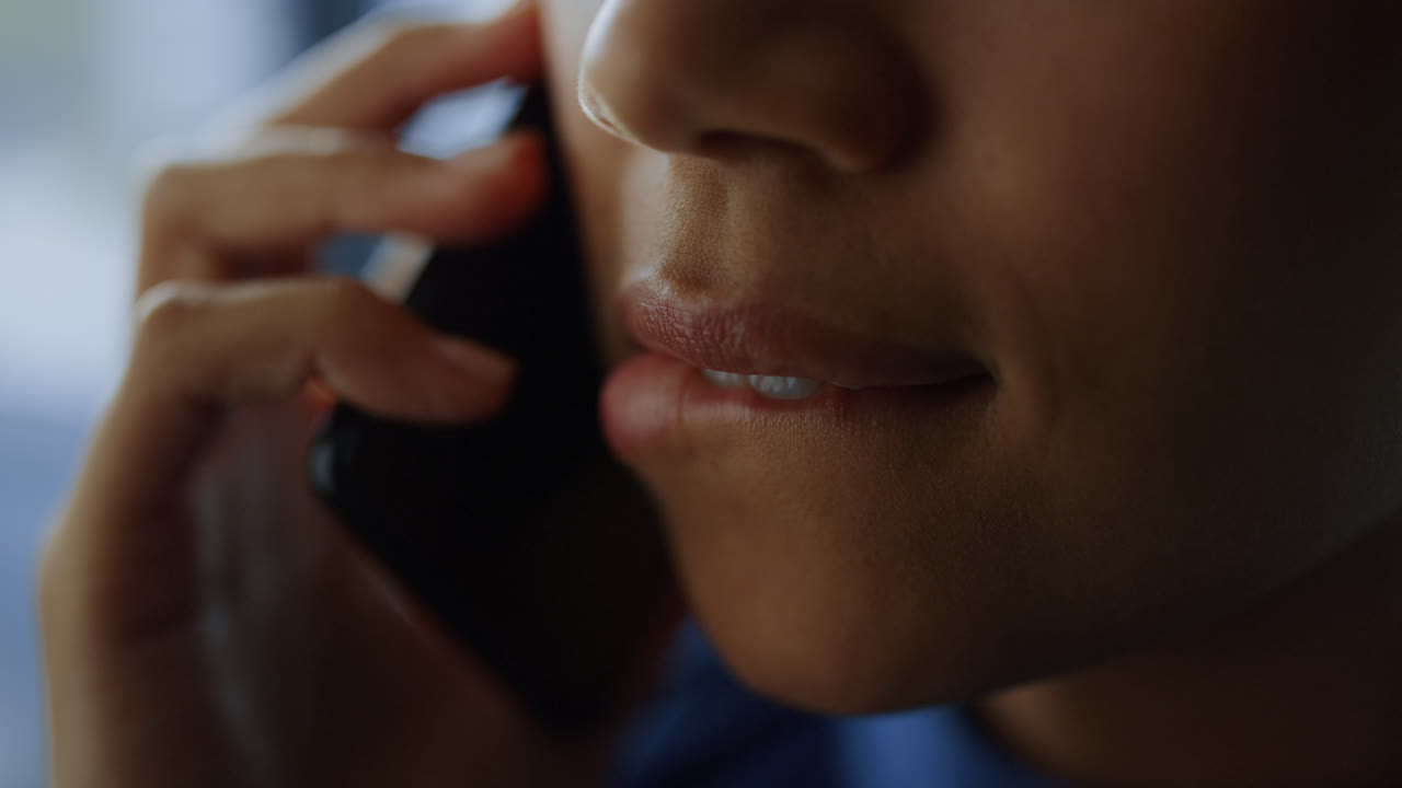 African american businesswoman face talking mobile phone. Girl biting lips