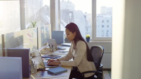 young asian businesswoman working on laptop in office