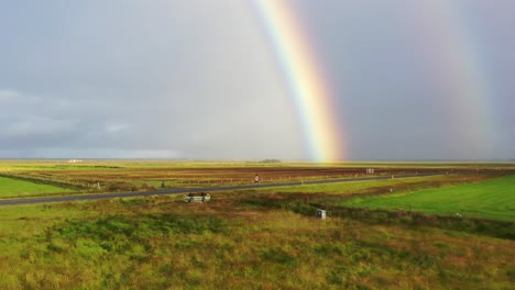 person-running-on-an-empty-street-with-a-rainbow-in-the-background