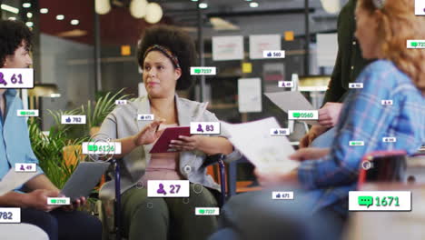 woman in wheelchair holding tablet collaborating with team in tech hub viewing floating data icons
