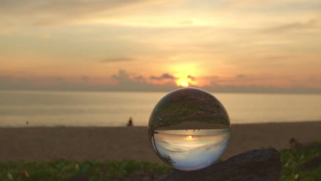 beautiful sunrise above the sea inside crystal ball.