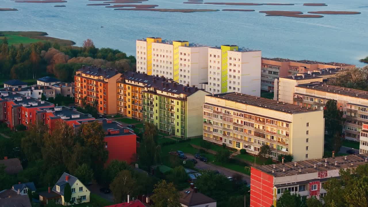 Aerial retreat reveals Liepaja Ezerkrasts apartments beside calm water