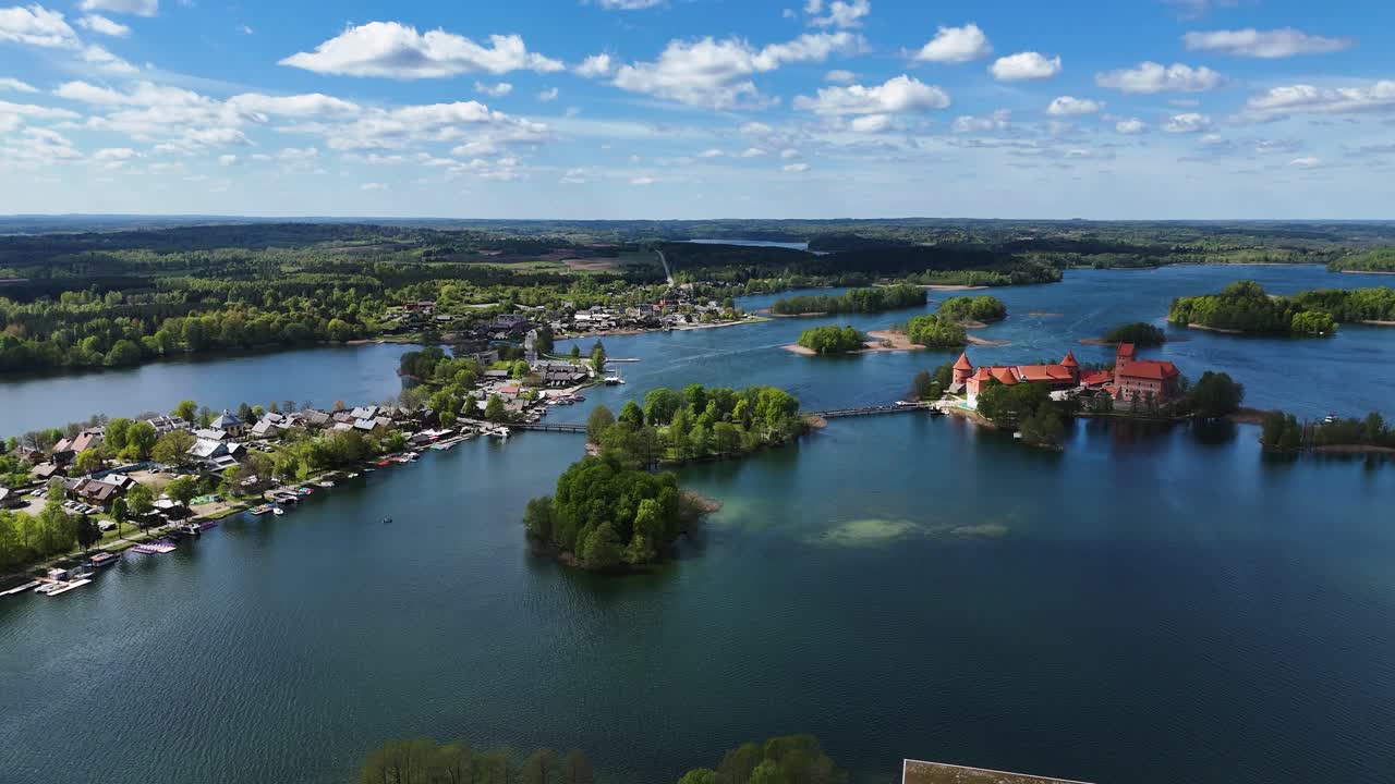 Trakai castle and town near blue deep lake in Lithuania, aerial orbit view
