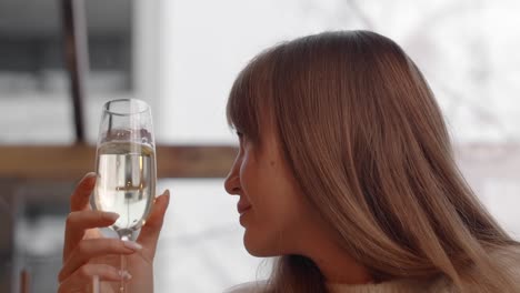 woman enjoying wine in winter cafe