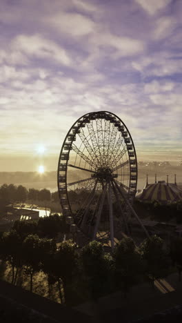 beautiful sunset view over a ferris wheel near a waterfront
