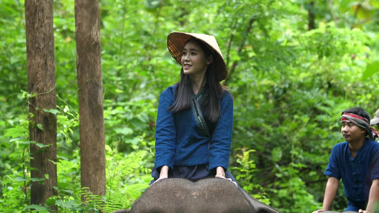 Woman Riding Elephant in a Tropical Forest