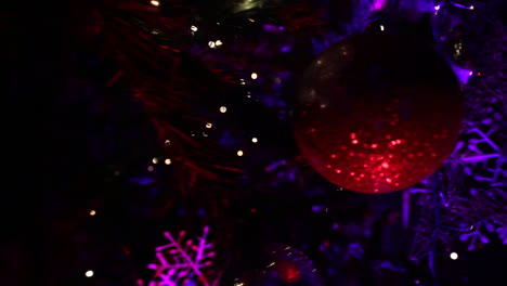 Christmas-tree-decorations-at-night-with-purple-lights---push-in