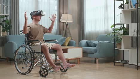 young asian boy sitting in a wheelchair while wearing virtual reality goggles at home