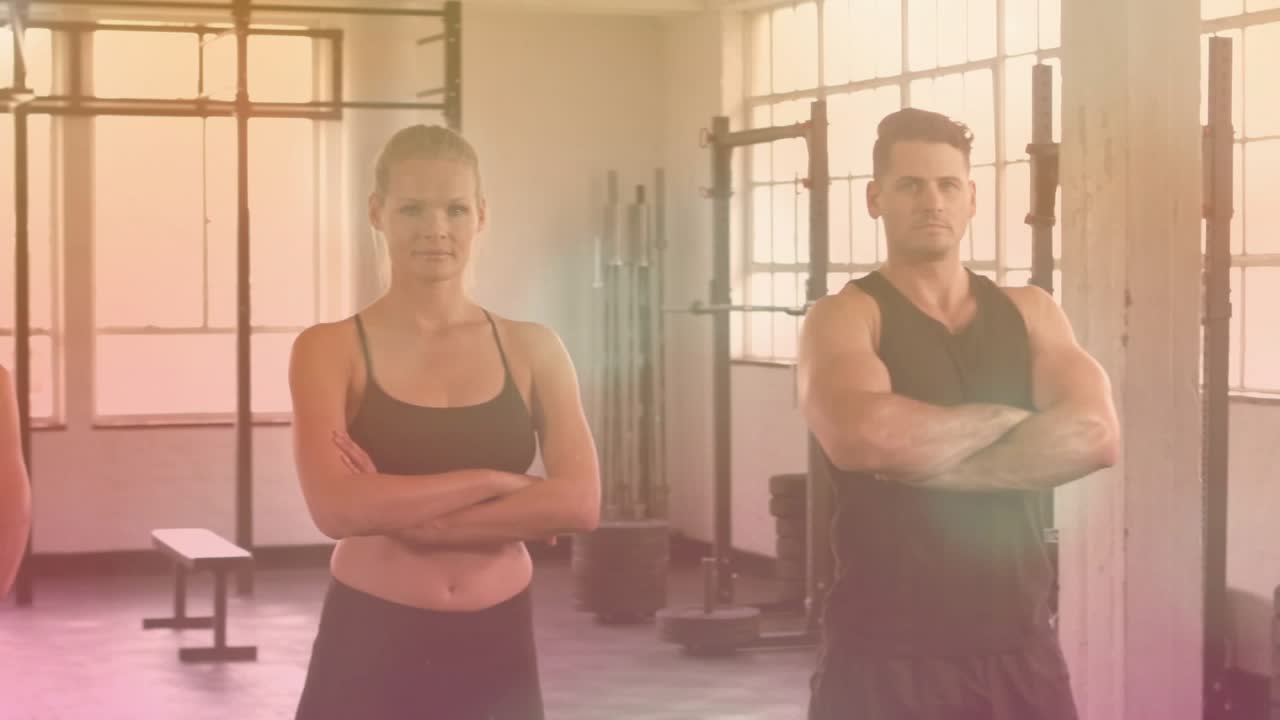Gym team holding arms crossed posing while camera pulling out flare revealing racks for promo
