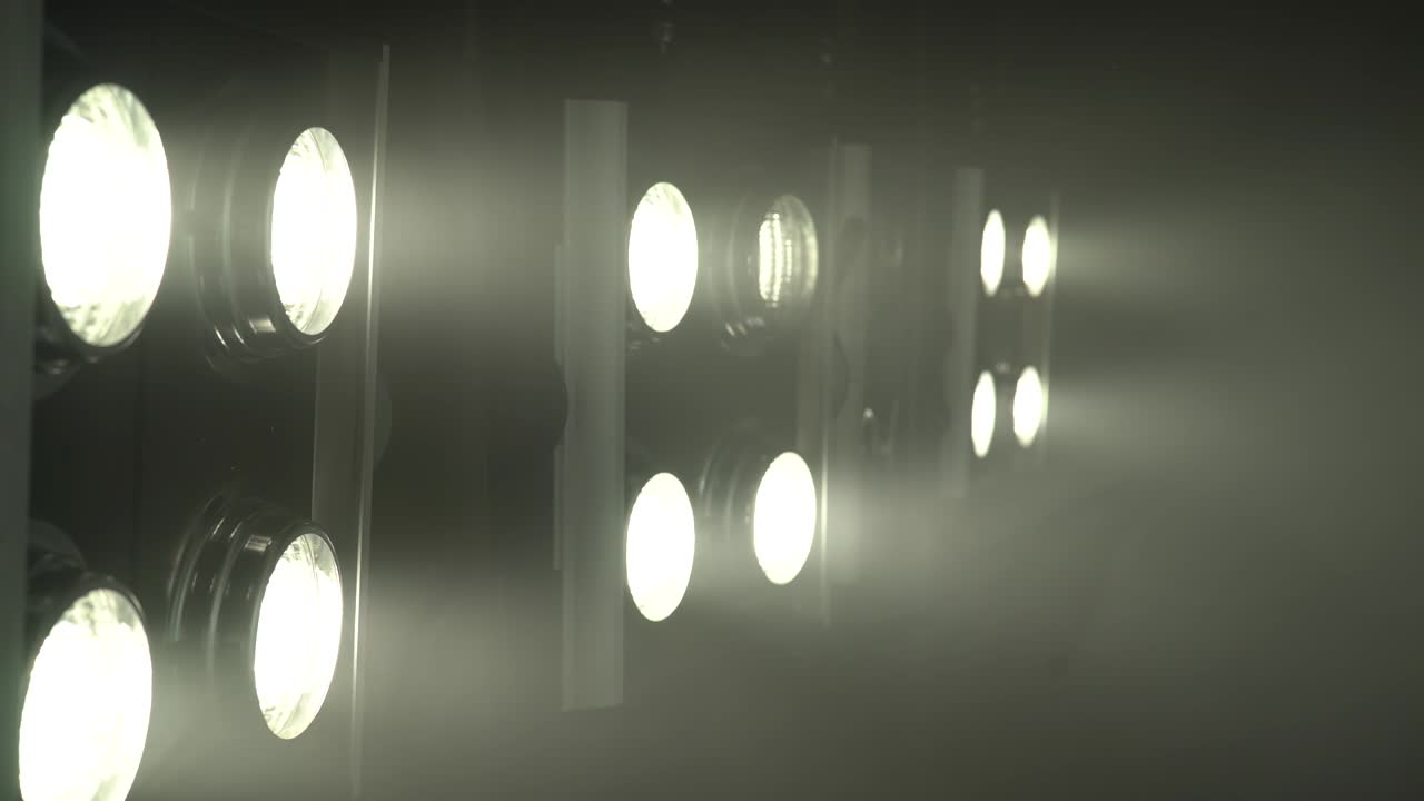 Burning projectors with bright light, two of them turn on and off