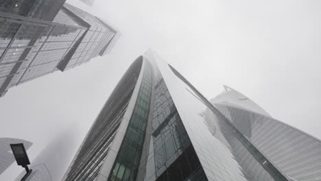 modern skyscrapers in a foggy city
