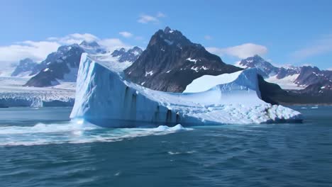 majestic iceberg surrounded by serene waters and breathtaking mountainous landscape captured in stunning video frames