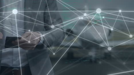 animation of data and network of connections over caucasian businessman using tablet