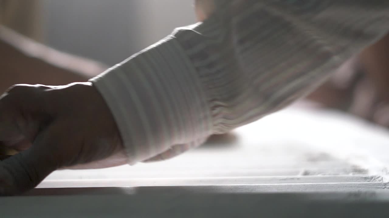Workers' Hands Polishing Surface Of A Corrugated Luxury Marble Tile - selective focus - slow motion