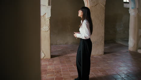 religious woman amazed by the beauty of an old church